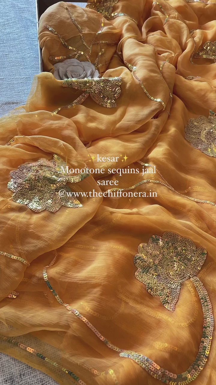 Kesar yellow shade on pure chiffon and jewelled intricately with monontone sequins jaal